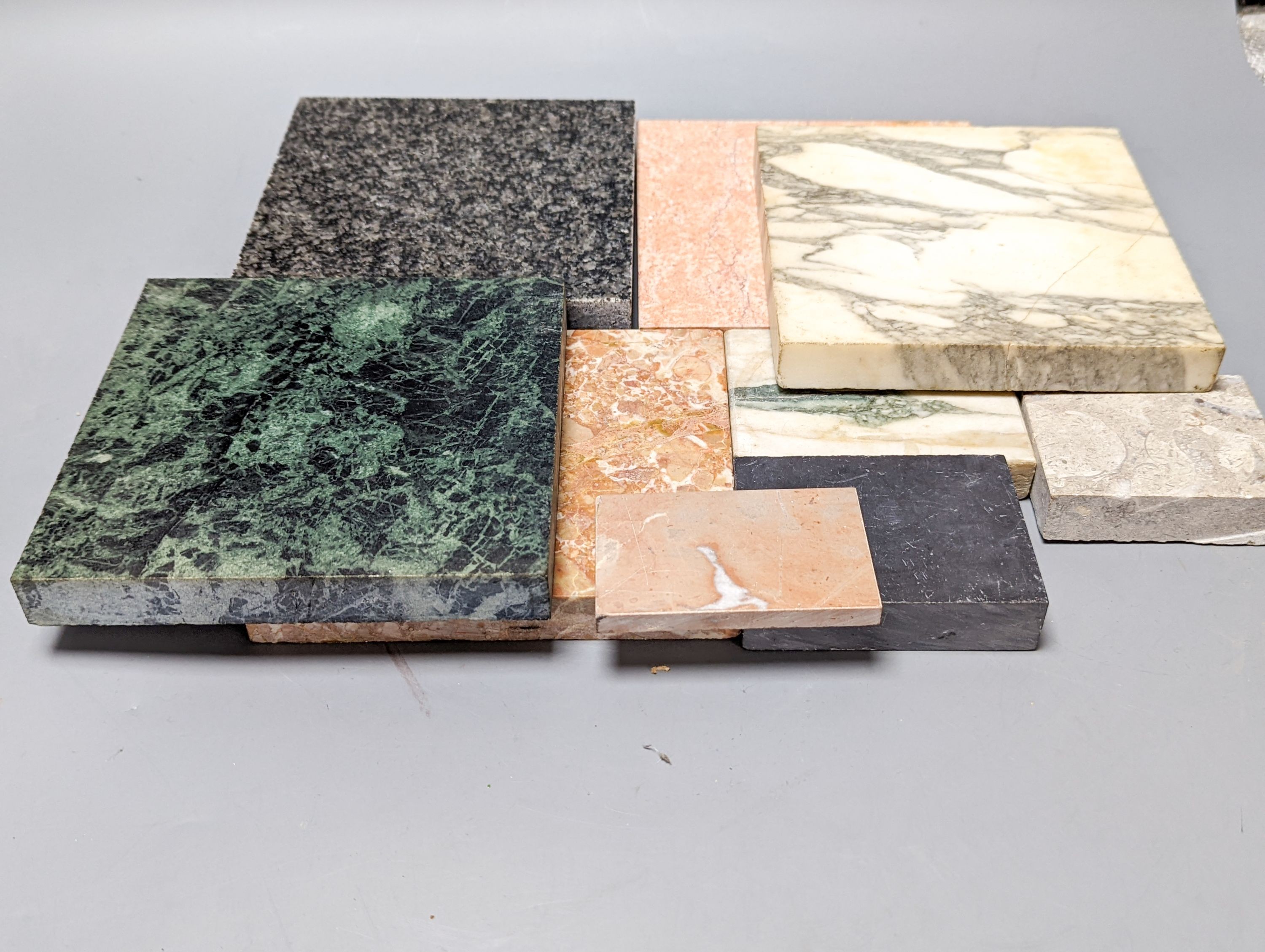 A group of cut stone samples, including marble and granite